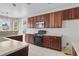 Bright kitchen featuring wooden cabinetry, a stove, and a microwave at 4747 Lewis And Clark Trl, Summerville, SC 29485