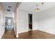 View of living room featuring hardwood floors and a dining area in need of renovation at 4747 Lewis And Clark Trl, Summerville, SC 29485