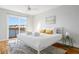 Light-filled bedroom with balcony access and waterfront views, decorated in neutral tones at 4979 Lake Palmetto, North Charleston, SC 29418