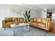 Modern living room featuring tan leather couches, a bright abstract painting, and stylish, sophisticated decor at 4979 Lake Palmetto, North Charleston, SC 29418