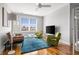 Bright living room featuring hardwood floors, a ceiling fan, and large window with neighborhood views at 4979 Lake Palmetto, North Charleston, SC 29418