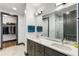 Bright bathroom with double vanity, sleek fixtures, marble countertops, large mirror, and walk-in closet at 5 Gadsdenboro St # 416, Charleston, SC 29401