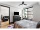 Bright bedroom featuring hardwood floors, ceiling fan, and large window with a view at 5 Gadsdenboro St # 416, Charleston, SC 29401