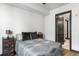 Bedroom featuring a minimalist design, comfortable bed, and simple furnishings, with ensuite bathroom at 5 Gadsdenboro St # 416, Charleston, SC 29401
