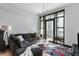 Bright living room with large windows, a comfortable sectional sofa, modern lighting, and stylish decor at 5 Gadsdenboro St # 416, Charleston, SC 29401