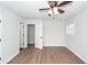 Bright bedroom with hardwood flooring, ceiling fan, and two access doors at 521 Savannah Rd, Ladson, SC 29456