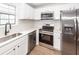 Modern kitchen with stainless steel appliances, a stainless sink, and stone countertops at 521 Savannah Rd, Ladson, SC 29456