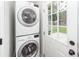 Laundry Room featuring stacked washer and dryer and access to back yard through a glass-paneled door at 521 Savannah Rd, Ladson, SC 29456