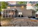 Exterior view of the house featuring a screened-in porch, patio, and outdoor seating area at 5400 Rock Creek Ct, North Charleston, SC 29420