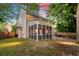 Exterior view of the house showcasing a screened-in porch and a spacious backyard at 5400 Rock Creek Ct, North Charleston, SC 29420