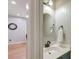 Powder room featuring a pedestal sink, round mirror, and wooden floors at 5400 Rock Creek Ct, North Charleston, SC 29420