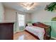Charming bedroom with hardwood floors, wainscoting, and a whimsical touch, illuminated by a ceiling fan at 5400 Rock Creek Ct, North Charleston, SC 29420