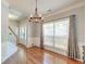 Elegant dining room featuring hardwood floors, large windows, decorative chandelier, and stylish wainscoting at 5400 Rock Creek Ct, North Charleston, SC 29420