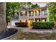 Inviting two-story home featuring a charming front porch, manicured landscaping, and a two car garage at 5400 Rock Creek Ct, North Charleston, SC 29420