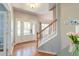 Inviting foyer with hardwood floors, a staircase, and natural light streaming through the front door at 5400 Rock Creek Ct, North Charleston, SC 29420