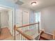 Hallway featuring wooden floors and white doors, leading to various rooms with natural lighting at 5400 Rock Creek Ct, North Charleston, SC 29420