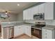 Bright kitchen with white cabinets, stainless steel appliances and light countertops at 5400 Rock Creek Ct, North Charleston, SC 29420