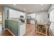 Bright, open kitchen with stainless steel appliances, white cabinets, and an adjacent dining area at 5400 Rock Creek Ct, North Charleston, SC 29420