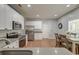 Well-lit kitchen features white cabinets, stainless steel appliances and a cozy breakfast nook at 5400 Rock Creek Ct, North Charleston, SC 29420