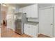 Kitchen featuring stainless steel refrigerator, white cabinets, and wooden floor at 5400 Rock Creek Ct, North Charleston, SC 29420