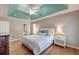 Beautiful main bedroom with tray ceilings, hardwood floors, ensuite bathroom, and abundant natural light at 5400 Rock Creek Ct, North Charleston, SC 29420