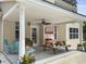 Cozy covered back patio with a ceiling fan, TV, and outdoor seating, perfect for relaxation and entertainment at 5403 Diston Ct, North Charleston, SC 29420