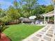 Serene backyard featuring lush grass, a pool, patio furniture, and a privacy fence at 5403 Diston Ct, North Charleston, SC 29420