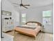 Bedroom with ceiling fan, two windows, and a decorative cabinet at 5403 Diston Ct, North Charleston, SC 29420