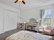 Bright bedroom with plush carpet, ceiling fan, closet, and adjacent Bedroom area, offering comfort and functionality at 5403 Diston Ct, North Charleston, SC 29420