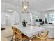 Bright, open-concept dining room with a modern chandelier, seamlessly connects to the living room and entryway at 5403 Diston Ct, North Charleston, SC 29420