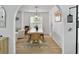 Open-concept dining area with stylish lighting fixture, adjacent to the living room and arched entryways creates a cozy atmosphere at 5403 Diston Ct, North Charleston, SC 29420