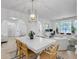 Open-concept dining room with a stylish light fixture, seamlessly connecting to living areas, perfect for entertaining at 5403 Diston Ct, North Charleston, SC 29420