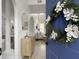 Inviting entryway with a blue front door, decorative wreath, stylish console table, and an arched entry to the main living space at 5403 Diston Ct, North Charleston, SC 29420