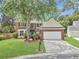 Beautiful two-story brick home with a well-manicured lawn and mature trees at 5403 Diston Ct, North Charleston, SC 29420