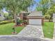 Charming brick front home with a manicured lawn, mature trees, and a two-car garage at 5403 Diston Ct, North Charleston, SC 29420