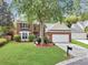 Charming brick front home with a manicured lawn, mature trees, and a two-car garage at 5403 Diston Ct, North Charleston, SC 29420