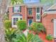 Charming brick home featuring a blue front door, lush landscaping, and a manicured lawn at 5403 Diston Ct, North Charleston, SC 29420