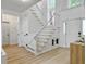 Spacious foyer featuring high ceilings, a staircase with a gate, and wood-look floors, creating a welcoming entrance at 5403 Diston Ct, North Charleston, SC 29420