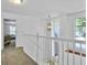 Bright hallway with a view overlooking the living room, featuring a modern chandelier and carpeted floor at 5403 Diston Ct, North Charleston, SC 29420