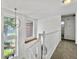 Bright hallway with a view overlooking the yard, featuring a modern chandelier and carpeted floor at 5403 Diston Ct, North Charleston, SC 29420
