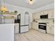 Bright kitchen with stainless steel appliances, floating shelves, and white countertops at 5403 Diston Ct, North Charleston, SC 29420