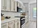 Well-lit kitchen features white cabinets, stainless steel appliances, and quartz countertops at 5403 Diston Ct, North Charleston, SC 29420