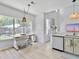 Eat-in kitchen with large window, modern lighting, and white cabinets at 5403 Diston Ct, North Charleston, SC 29420