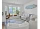 Comfortable living space with a large bay window, desk, sofa, and a unique surfboard decoration on the wall at 5403 Diston Ct, North Charleston, SC 29420