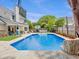 Spacious backyard with a sparkling pool, patio seating, and well-maintained lawn at 5403 Diston Ct, North Charleston, SC 29420