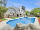 A stunning backyard pool and patio with a rock waterfall feature make a relaxing outdoor oasis at 5403 Diston Ct, North Charleston, SC 29420