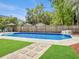 The in-ground pool, surrounded by a concrete patio and lush landscaping, adds to the home's appeal at 5403 Diston Ct, North Charleston, SC 29420
