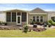 Wonderful backyard featuring stone patio surrounded by manicured landscaping and green grass at 559 Eastern Isle Ave, Summerville, SC 29486
