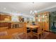 Dining area with wooden table set and china cabinet with decor, adjacent to the kitchen at 559 Eastern Isle Ave, Summerville, SC 29486