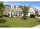 Beautiful home with well-maintained lawn, mature landscaping, and inviting front porch at 559 Eastern Isle Ave, Summerville, SC 29486
